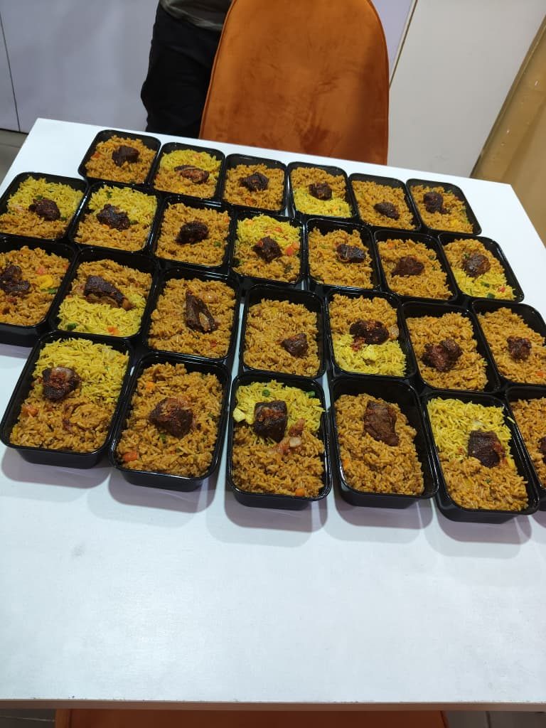 Trays of smokey party jollof rice packed for delivery
